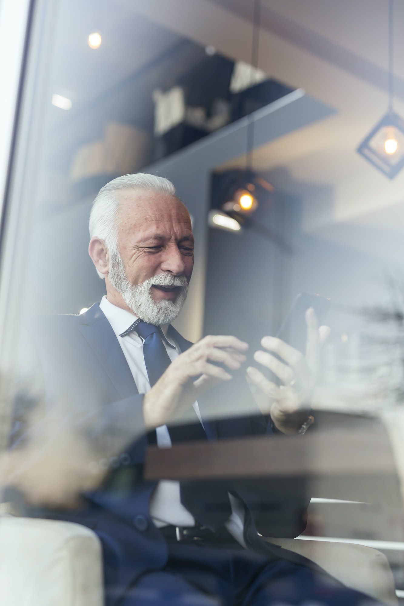 Businessman sending an email using smart phone