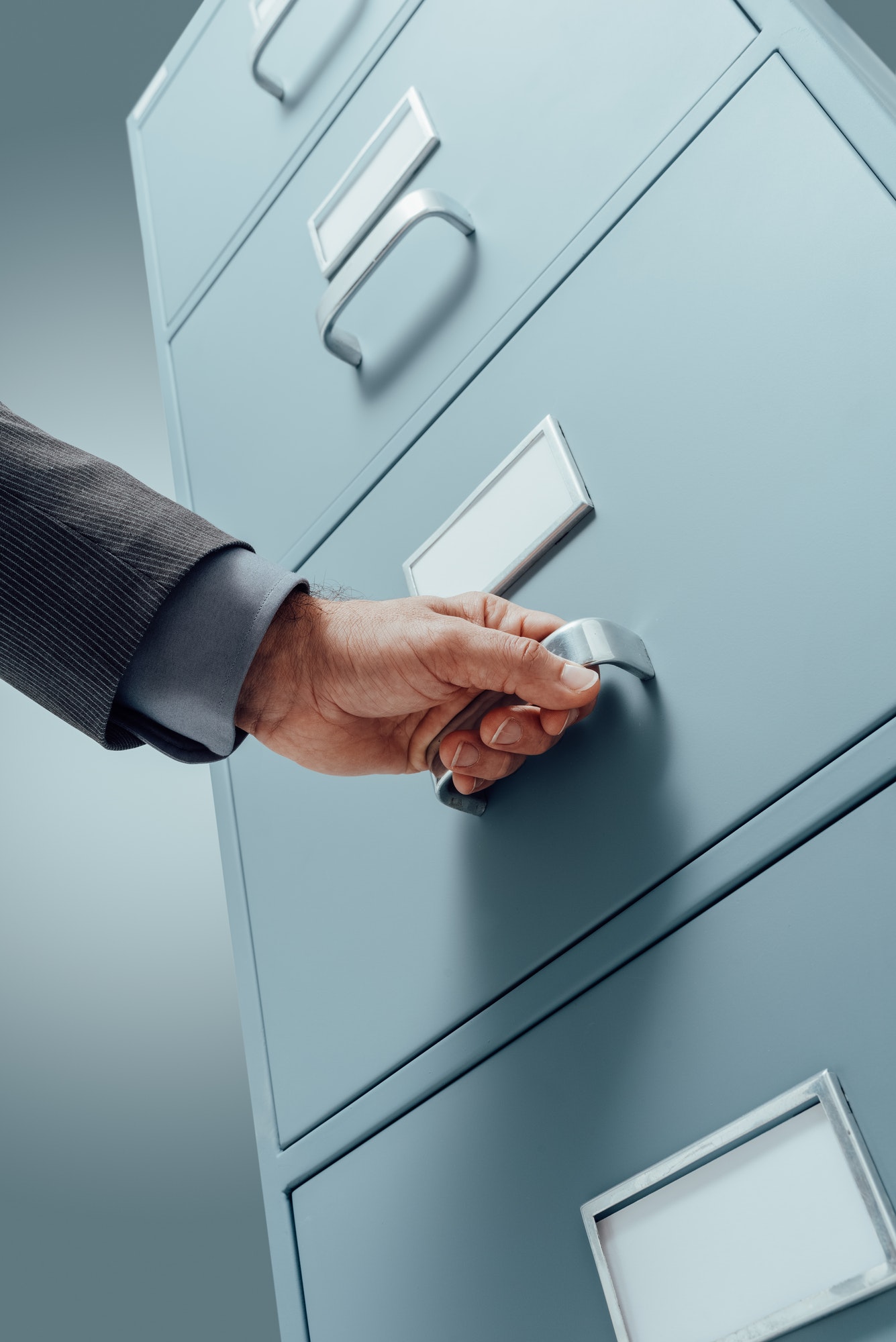 Office clerk searching files in the filing cabinet